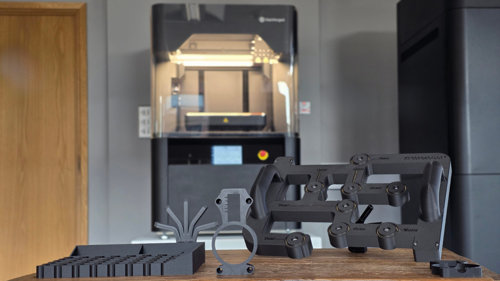5 manufacturing 3D printed parts in front of FX10